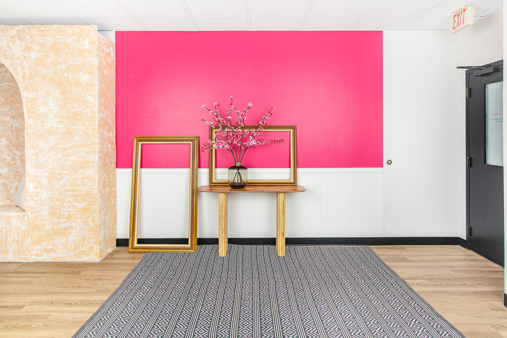 Pink entryway wall, cherry blossoms, gold frames for video recording